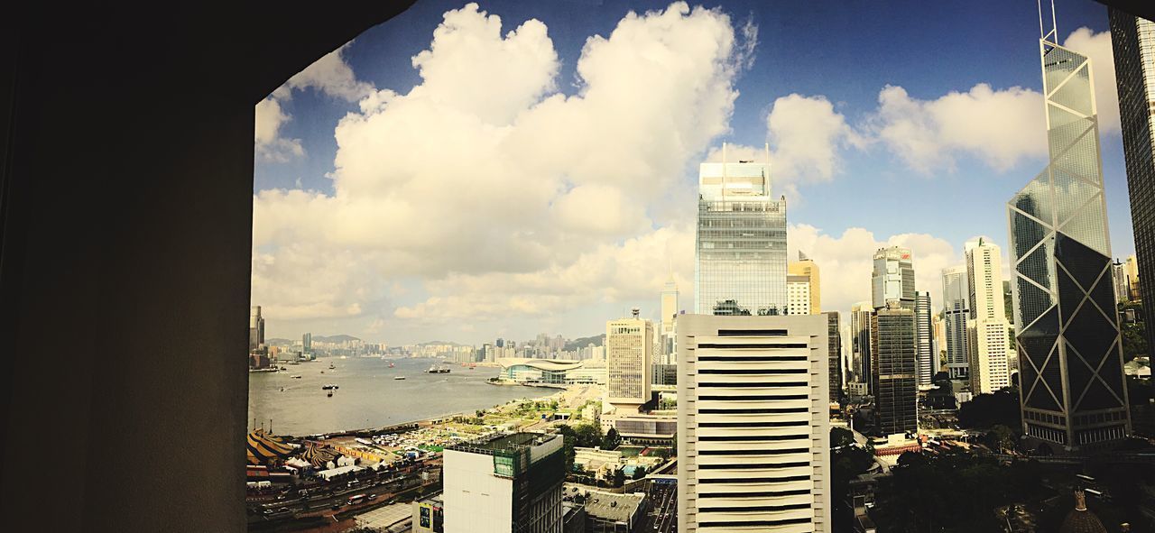 BUILDINGS IN CITY AGAINST CLOUDY SKY