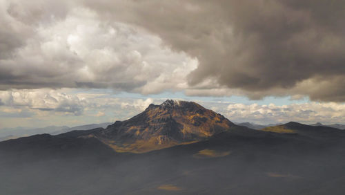 Scenic view of mountains against cloudy sky