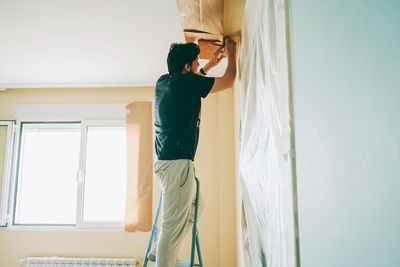 Side view of man working at home