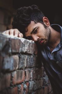 Portrait of young man against wall