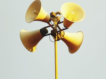 Low angle view of yellow pole against white background