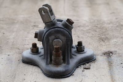 Close-up of rusty metal mounted on wood