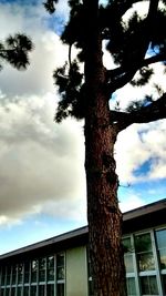 Low angle view of building against cloudy sky