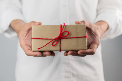 Midsection of man holding paper in box