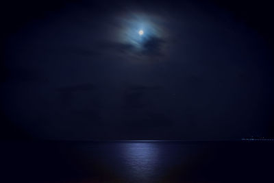 Scenic view of sea against sky at night