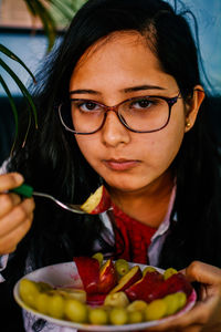 Portrait of young woman eating food. women need quality food for diet.