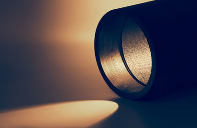 Close-up of illuminated flashlight on table