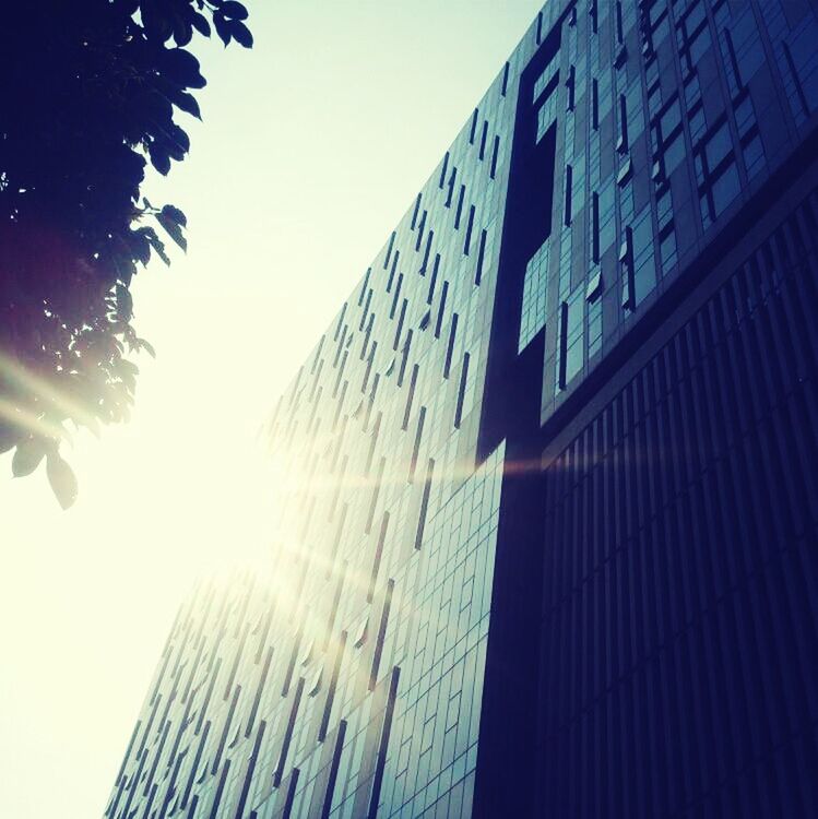 building exterior, architecture, low angle view, built structure, skyscraper, clear sky, office building, tall - high, modern, city, tower, building, blue, sky, sunlight, glass - material, reflection, outdoors, day, no people