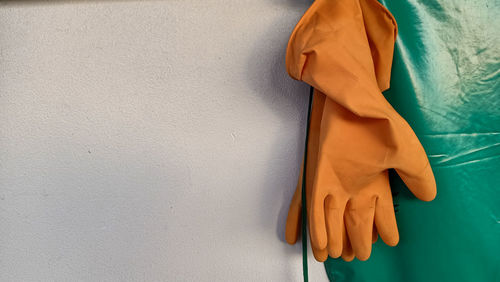 Midsection of woman standing against wall