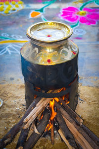 High angle view of burning candles on wooden table
