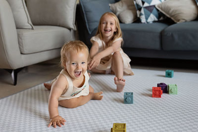 High angle view of boy sitting on sofa at home