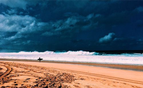 Scenic view of sea against cloudy sky