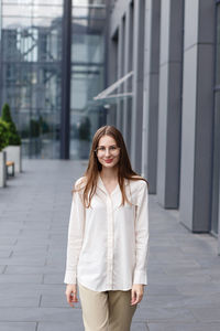 Young woman in business clothes near her office