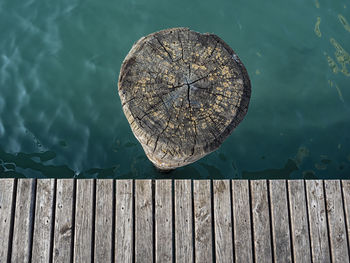High angle view of wooden post on pier over lake