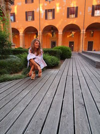 Full length of woman sitting outdoors