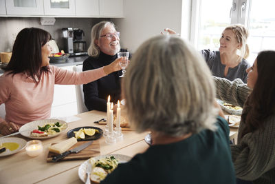 Family raising toast during dinner