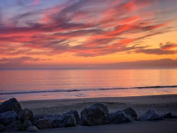 Scenic view of sea against romantic sky at sunset