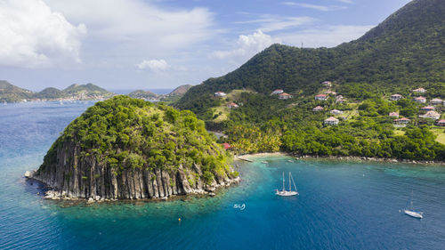 Scenic view of sea and mountains against sky