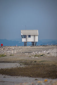 Lifeguard hut on beach against clear sky