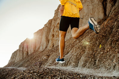 Dynamic running man runner on sandy beach