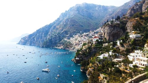 Scenic view of sea and mountains against sky