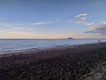 Scenic view of beach against sky during sunset