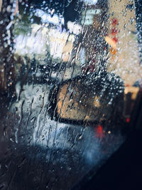 Close-up of wet glass window in rainy season