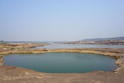 Scenic view of sea against clear blue sky