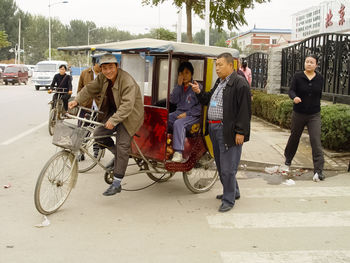 People walking on road in city