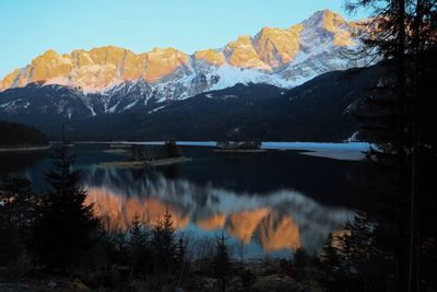 Scenic view of lake and mountains against sky during winter