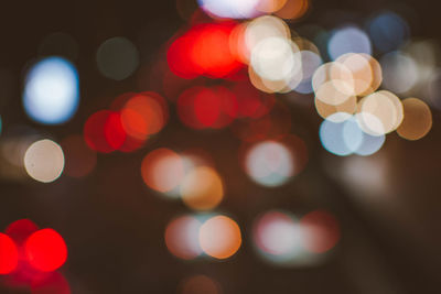 Defocused image of illuminated city at night