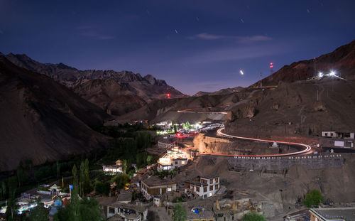 High angle view of illuminated city against sky at night