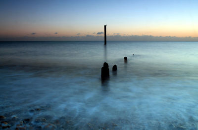 Scenic view of sea against sky at sunset