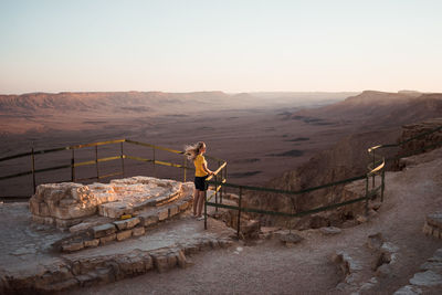 Full length of woman standing at observation point