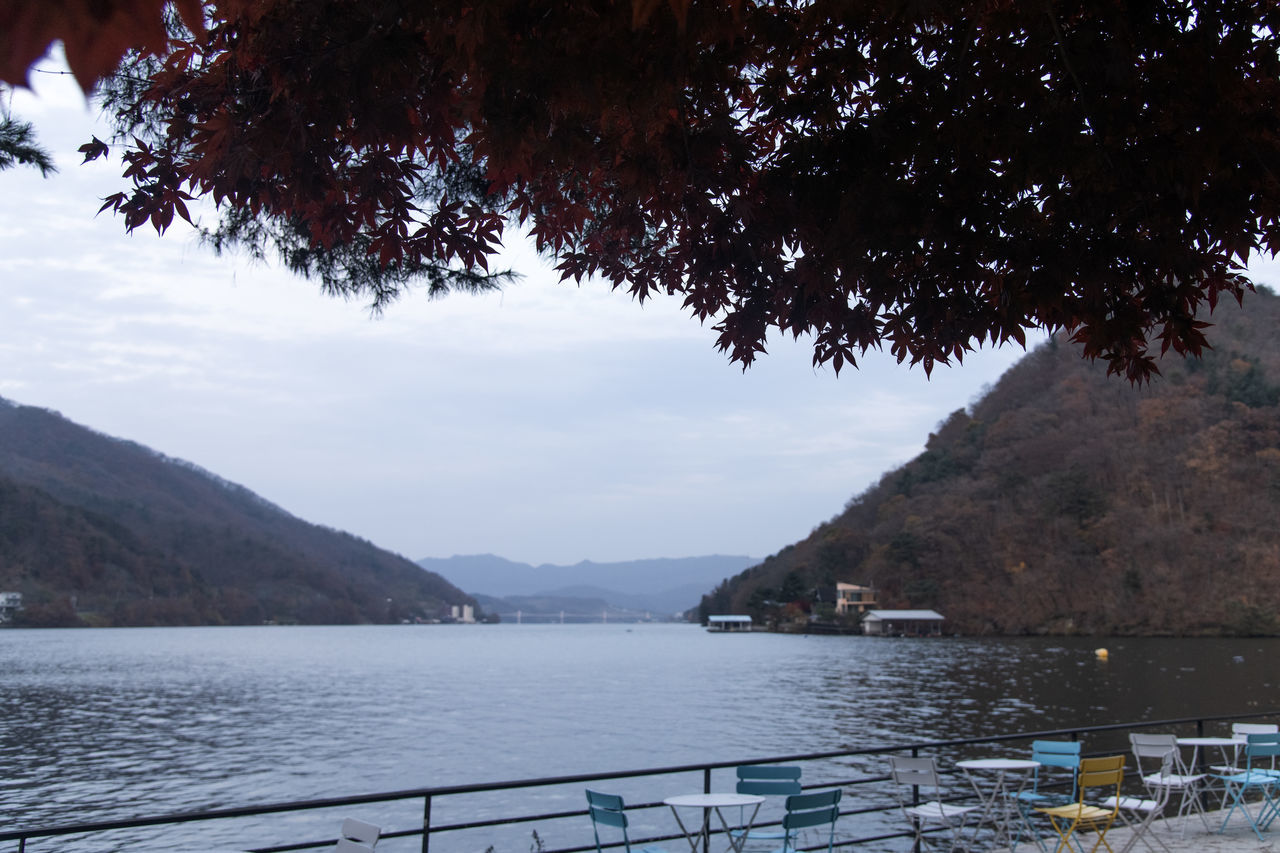 water, mountain, tree, nature, scenics - nature, sky, beauty in nature, lake, plant, body of water, reflection, no people, tranquility, tranquil scene, transportation, mountain range, nautical vessel, land, day, travel destinations, outdoors, travel, environment, beach, architecture, landscape, non-urban scene, tourism, idyllic, cloud