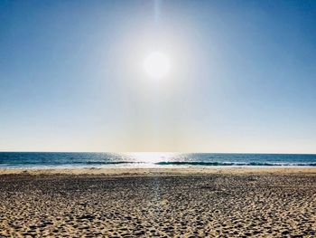 Scenic view of sea against clear sky on sunny day