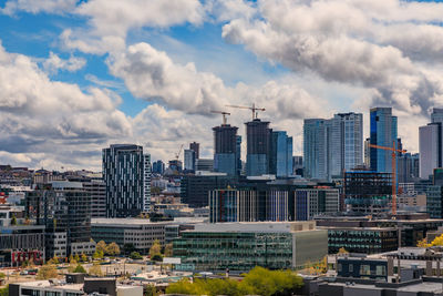 Cityscape against cloudy sky