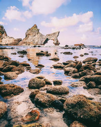 Aerial view of rock on beach against sky