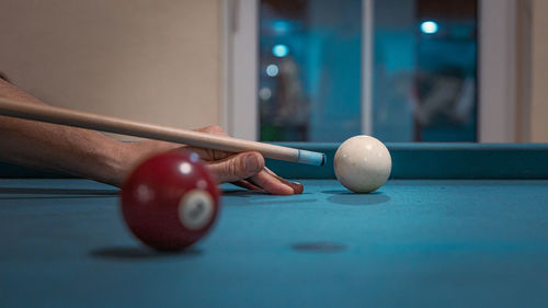 Hand holding ball on table