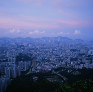 High angle view of buildings in city at sunset