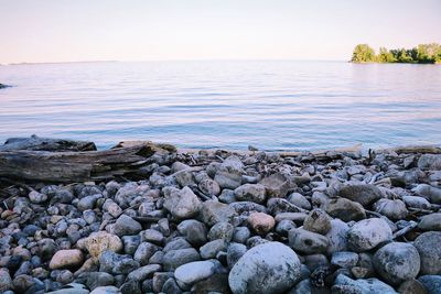 Pebbles on beach against sky