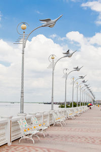 Seagulls on street against sky