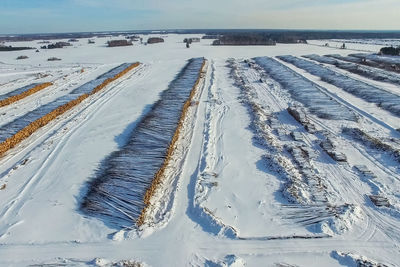 Panoramic view of snow covered land and sea against sky