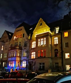 Illuminated buildings against sky at night