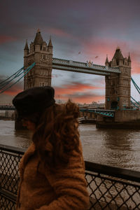 Tower bridge over river with city in background