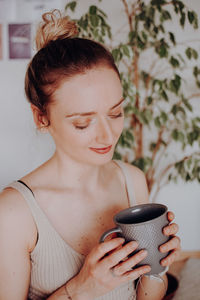 Portrait of young woman using mobile phone