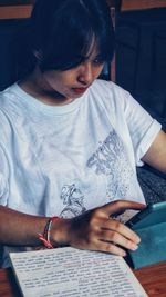 Close-up of woman using laptop at home