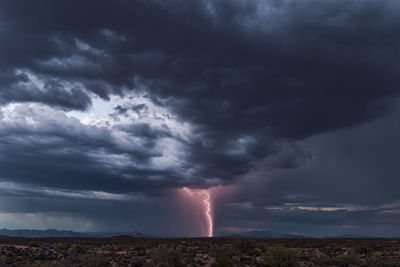 Scenic view of storm clouds over lightning