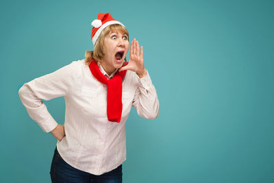 Mid adult man standing against blue background