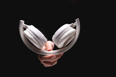 Close-up of hand against black background